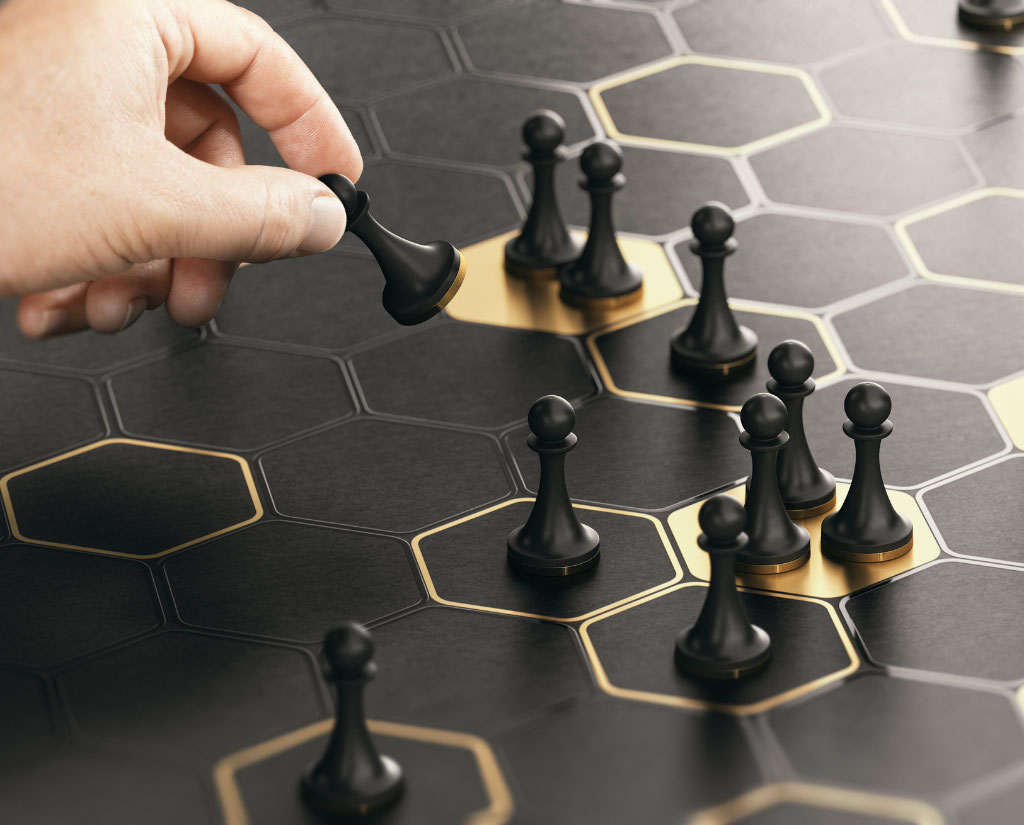 a hand places a pawn chess piece on a board with black and gold honeycombs, with more pawns on the bg